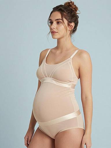 Thoughtful Pregnant Woman in Champagne Maternity Lingerie