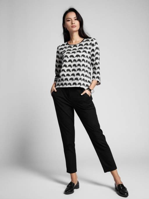 Woman in Elephant Print Top and Black Trousers
