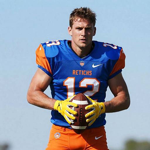 Male Football Player Holding Ball