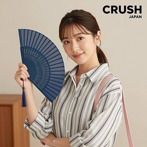Charming Asian Woman with Blue Hand Fan