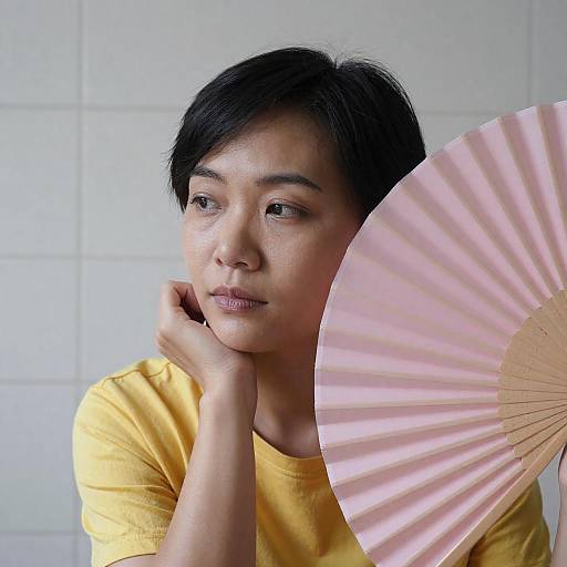 Contemplative Asian Woman with Fan