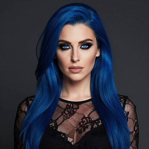Photograph of a woman with striking blue hair, intense blue eyes, and black lace top, against a dark gray background.