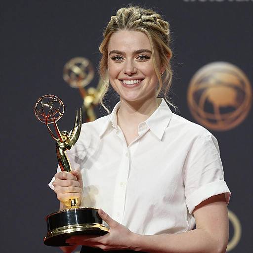 Smiling Woman Holding Emmy Award