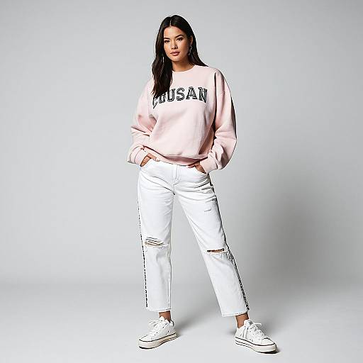Stylish woman in pink sweatshirt and white jeans