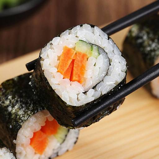 Close-up of Vegetable Sushi Roll on Chopsticks