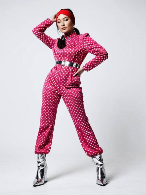 Woman in Retro-Futuristic Pink Polka Dot Jumpsuit