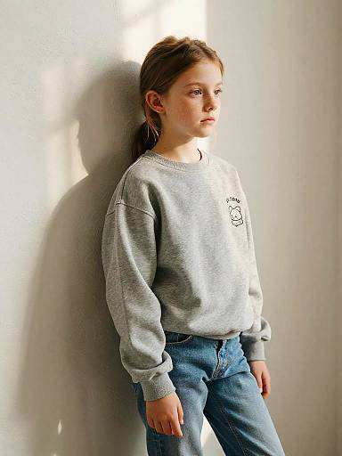 Freckled Girl in Grey Sweatshirt and Jeans