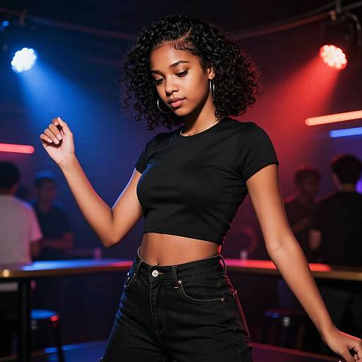 Photograph of a confident Black woman with curly hair, wearing a black crop top and high-waisted jeans, dancing under colorful stage lights in a