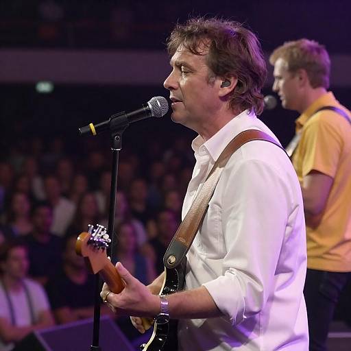 Middle-Aged Guitarist Singing Under Purple Lights