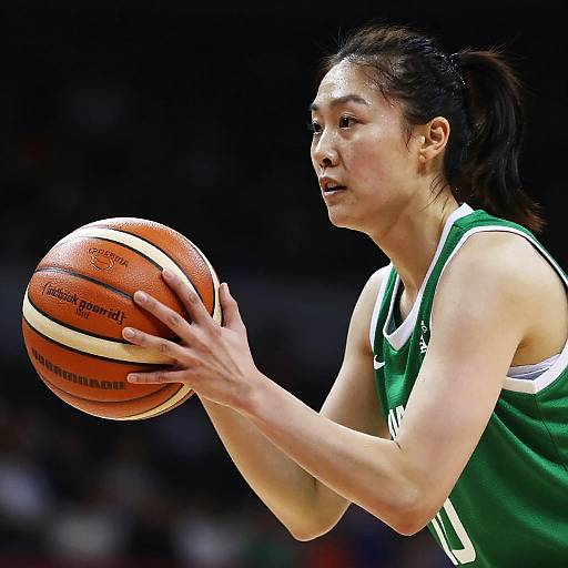 Woman Playing Basketball in Green Uniform