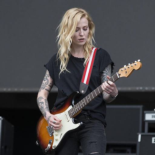 Blonde Tattooed Woman Playing Electric Guitar