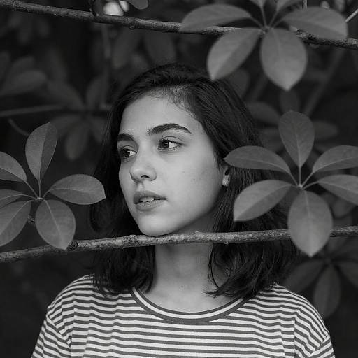 High-Contrast Black-and-White Portrait of Woman Among Branches
