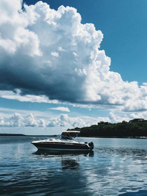Motorboat on Reflective Water Under Dramatic Clouds
