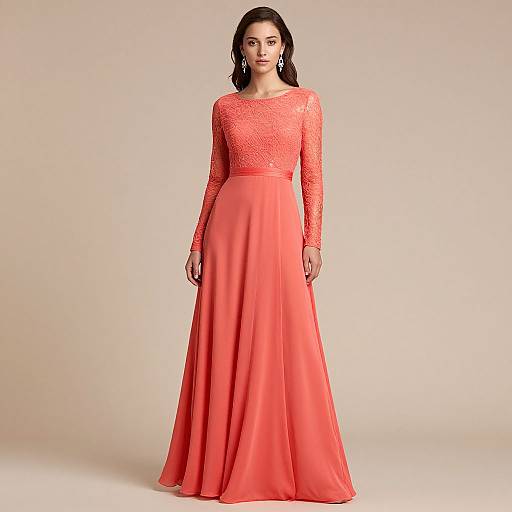 Photograph of a young woman with medium brown skin and black hair, wearing a long-sleeved, lace coral gown with a flowing skirt, standing