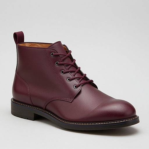 Photograph of a single, deep maroon leather ankle boot with laces, black rubber sole, and a small pull tab at the back. White
