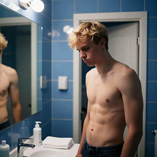 Young Man in Blue-Tiled Bathroom