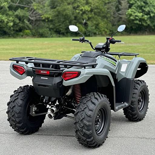 Photograph of a gray, four-wheeled, all-terrain STX1100 Polaris ATV with large black tires, red tail lights,