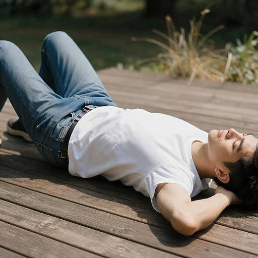 Sunlit Man Resting on Wooden Deck