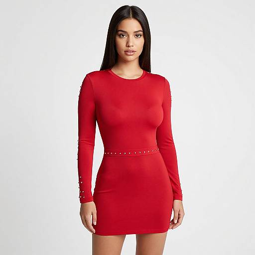 Photograph of a young woman with long black hair, wearing a form-fitting, long-sleeve red dress with studded belt, standing against