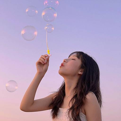 Young Woman Blowing Iridescent Bubbles