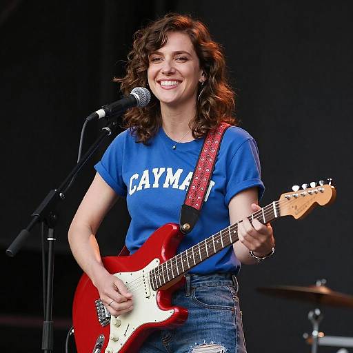 Smiling Woman Playing Red Electric Guitar