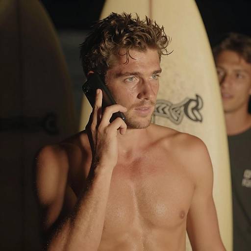 Shirtless Man with Surfboard and Phone