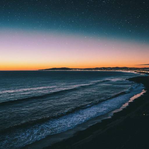 Starry Ocean Sunset with City Lights
