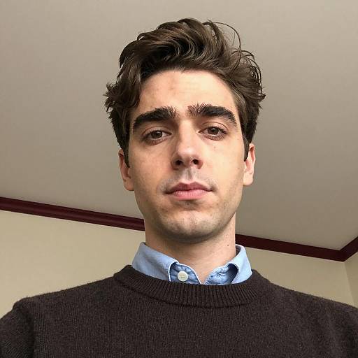 Young man with neutral expression indoors