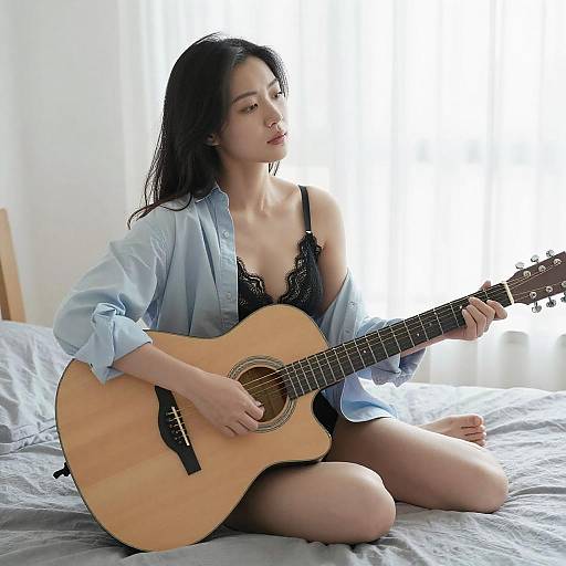Thoughtful Asian Woman with Guitar