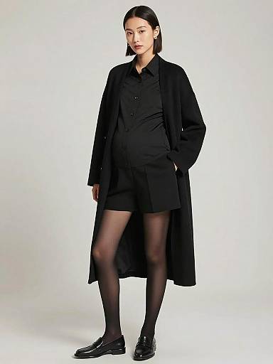 Pregnant Woman in Sleek Black Maternity Outfit