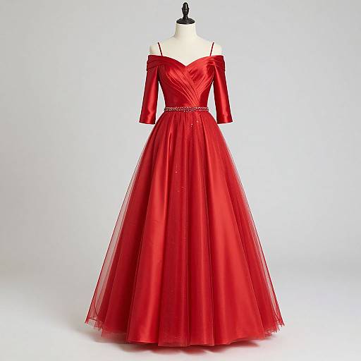 Photograph of a red, off-shoulder, long-sleeved, full-length, tulle ball gown with a heart-shaped bodice and