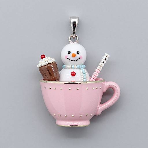 Adorable pink teacup charm with a snowman, chocolate cupcake, and candy cane, hanging by a silver loop against a light blue background