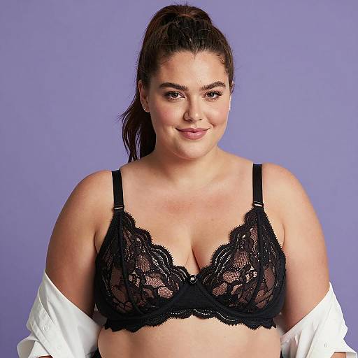Plus-sized woman in black lace bra on purple background