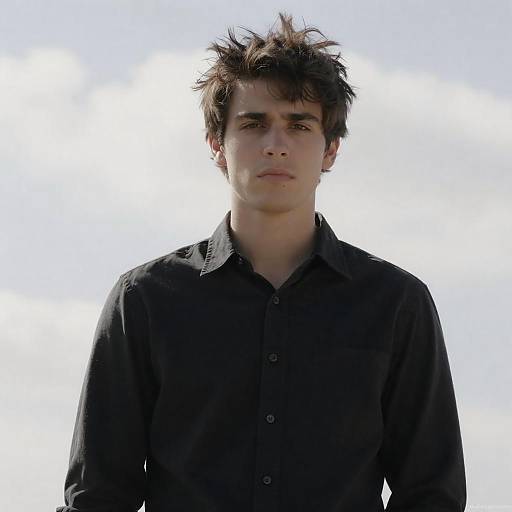 Young Man in Black Shirt Against Cloudy Sky