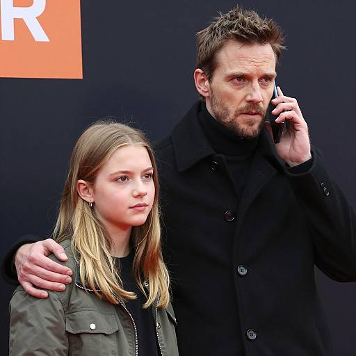 Man Talking on Phone with Arm Around Teen Girl