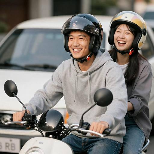 Young couple riding motorcycle with helmets