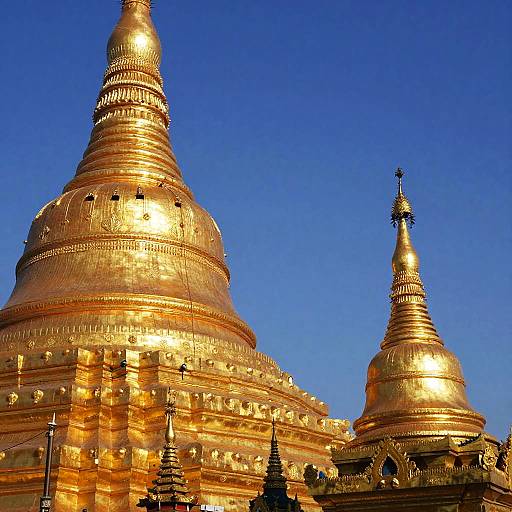 Golden Buddhist Stupas Under Blue Sky