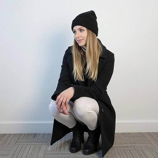 Young Woman Crouching in Winter Wear