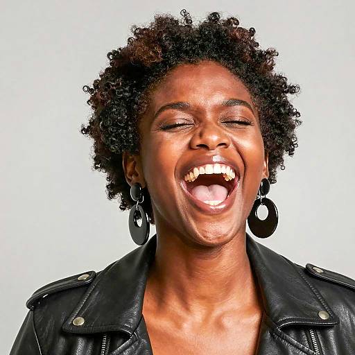 Joyful Black Woman in Leather Jacket