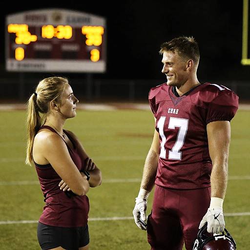 Nighttime Football Field Teammate Moment