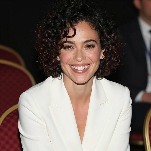 Smiling Woman in White Blazer