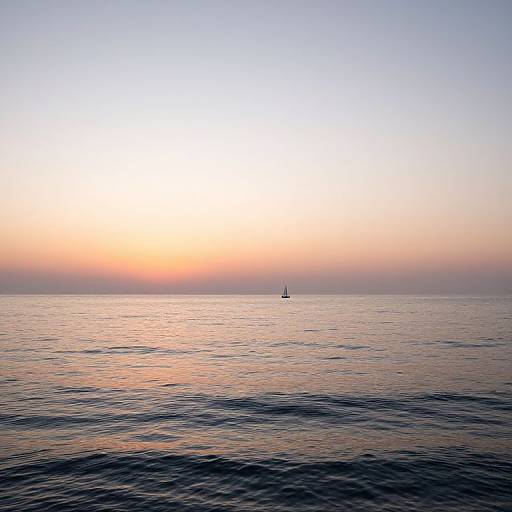 Photograph of a serene ocean at sunset, with a small sailboat in the distance, calm water reflecting warm orange and blue hues.