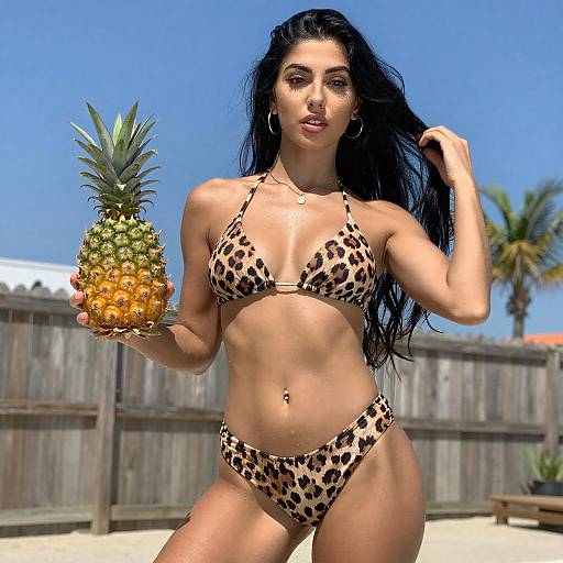 Young Woman in Leopard Bikini with Pineapple