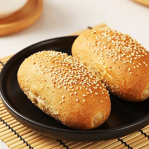 Sesame Bread Rolls on Black Plate