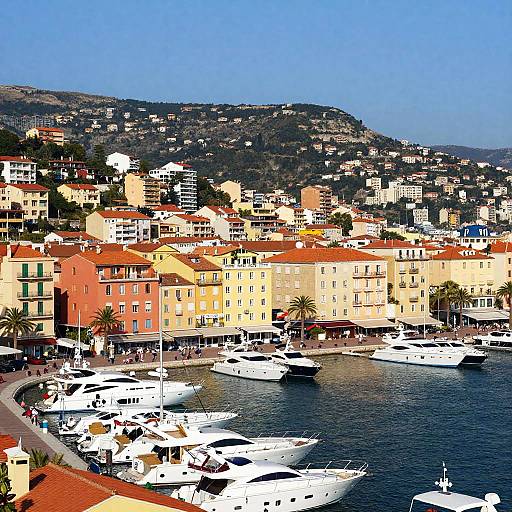 Vibrant coastal town photograph: colorful buildings, red-tiled roofs, crowded marina with white yachts, hilly background, clear blue sky