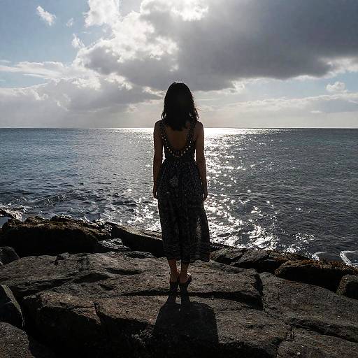 Solitary Woman on Rocky Shoreline