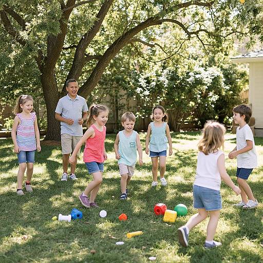 Photograph of six children, three boys, three girls, playing with colorful balls in a sunlit, grassy backyard under a large tree.