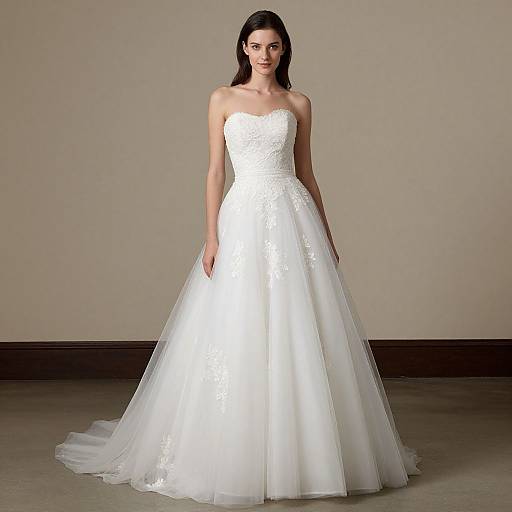 Photograph of a fair-skinned woman with dark hair in a strapless, white, lace-trimmed wedding gown with a full tulle skirt