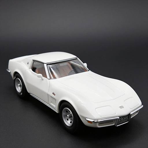 Photograph of a white, vintage sports car with a sleek, angular design, chrome details, and black background. Car is angled slightly to the right
