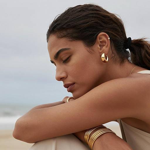 Calm Woman with Gold Jewelry by the Beach